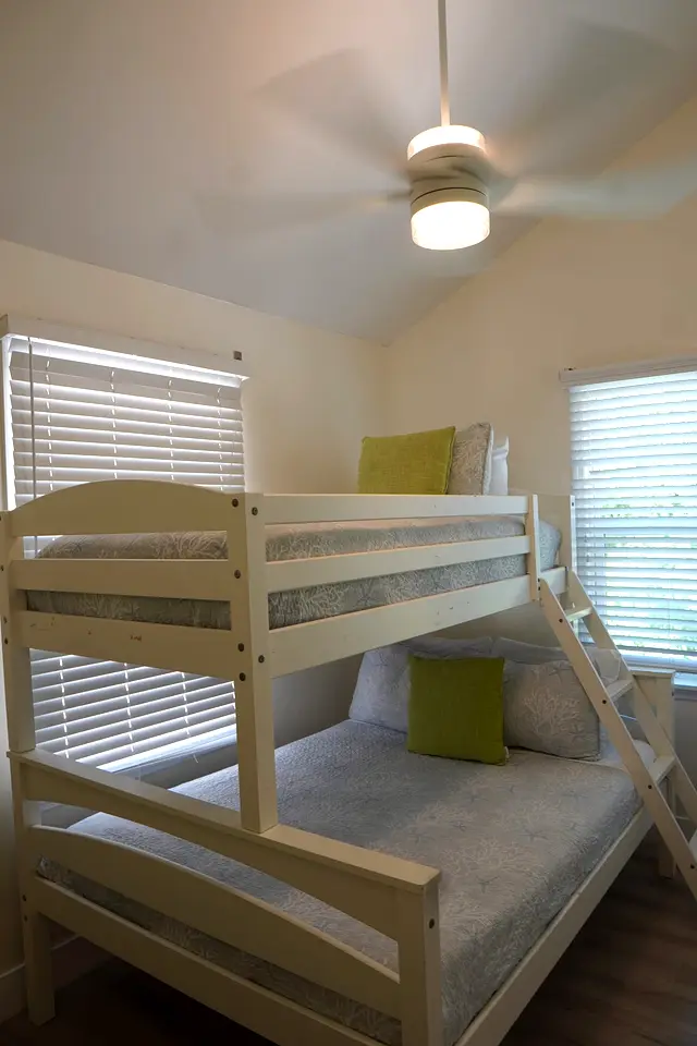 Second bedroom at villa 5012 with a twin-over-full bunk bed under a ceiling fan