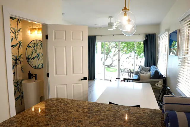 Looking from the kitchen counter at villa 5012, through the living area to the porch and the water