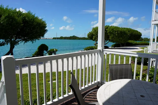Porch at villa 5012 looking across the lawn to the bay