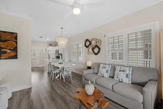Living room at villa 5092 with a grey sofa and shuttered windows